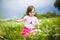 Beautiful carefree girl playing outdoors in field