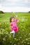 Beautiful carefree girl playing outdoors in field