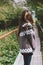 Beautiful carefree long hair asian girl in knitted nordic sweater in autumn nature park