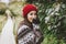 Beautiful carefree long hair asian girl in the red hat and knitted nordic sweater in autumn nature park, travel adventure