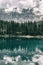 The beautiful Carezza lake with the Latemar mountain group in the background. Dolomites, Nova Levante, Bolzano, Italy.