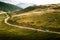 A beautiful Carpathian scenery with a road and a car