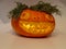 Beautiful carved pumpkin, decorated with black berries, beautiful yellow teeth, big mouth