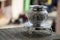 Beautiful carved silver pot or kalash and stand used in hindu rituals, on blur background