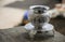 Beautiful carved silver pot or kalash and stand used in hindu rituals, on blur background