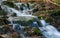 Beautiful cascading waterfall over natural rocks.