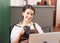 Beautiful caucasian barista woman sits relaxing to drink hot coffee in breaking time and happy to use laptop at coffee shop