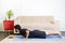 Beautiful caucasian bearded man in black clothes on blue yogamat doing chaturanga or Four-Limbed Staff Pose