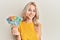 Beautiful caucasian blonde girl holding australian dollars looking positive and happy standing and smiling with a confident smile