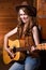 Beautiful caucasian cowgirl with guitar