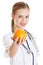 Beautiful caucasian doctor or nurse holding an orange.