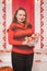 Beautiful caucasian emotional chubby woman with apples in small basket on white house background alone