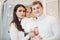 Beautiful Caucasian family at Christmas.Brunette mother and father with adorable daughter smiling at camera.