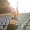 Beautiful caucasian girl athlete raised her hands up as a winner