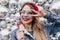 Beautiful caucasian girl eating candy with smile on sparkle background. Charming blonde woman posin