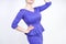 Beautiful caucasian girl with short hair and plus size body dressed in blue medium length dress in business style with peplum at t