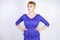 Beautiful caucasian girl with short hair and plus size body dressed in blue medium length dress in business style with peplum at t