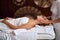 Beautiful caucasian lady getting face massage in beauty spa lying with closed eyes