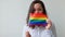 Beautiful caucasian lesbian girl with LGBT rainbow flag isolated on white background looking happy and excited