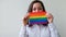 Beautiful caucasian lesbian girl with LGBT rainbow flag isolated on white background looking happy and excited