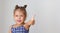 Beautiful caucasian little girl child kid of 5 years showing thumb up on grey background with copy space