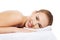Beautiful caucasian naked woman lying on a massage table and rel
