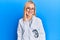 Beautiful caucasian oculist woman wearing robe and optometry glasses looking positive and happy standing and smiling with a