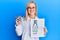 Beautiful caucasian optician woman holding optometry glasses and medical exam smiling with a happy and cool smile on face