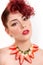 Beautiful Caucasian redhead woman looking sensual with open mouth and tilted head, having necklace of strawberries, red glitter o