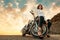 A beautiful caucasian sexy woman in a high heels, confidently posing sitting on a front wheel of motorcycle. Bottom view