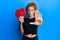 Beautiful caucasian teenager girl holding red ping pong rackets with open hand doing stop sign with serious and confident