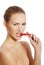 Beautiful caucasian topless woman with chili pepper in mouth.
