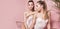 Beautiful caucasian twins female models on pink background.