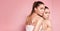 Beautiful caucasian twins female models on pink background.