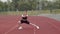 Beautiful Caucasian woman in black shorts, a tank top and white sneakers does rolling from foot to foot at a running