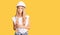 Beautiful caucasian woman with blonde hair wearing hardhat and builder clothes thinking attitude and sober expression looking self