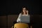 Beautiful caucasian woman concentrated while using laptop in a modern workspace. Cute young business woman speaking on the phone