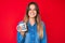 Beautiful caucasian woman drinking from i am the boss coffee cup looking positive and happy standing and smiling with a confident