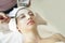 Beautiful caucasian woman having mask, lying on spa. Facial treatment in Spa salon