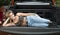 Beautiful Caucasian woman poses in bed of truck