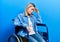 Beautiful caucasian woman sitting on wheelchair tired rubbing nose and eyes feeling fatigue and headache