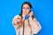 Beautiful caucasian woman speaking on vintage telephone pointing with finger to the camera and to you, confident gesture looking