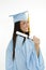 Beautiful Caucasian woman wearing a blue graduation gown holding diploma