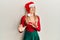 Beautiful caucasian woman wearing christmas costume and hat disgusted expression, displeased and fearful doing disgust face