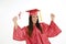 Beautiful Caucasian woman wearing a red graduation gown holding diploma