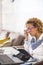 Beautiful caucasian young woman at home work or study with two personal laptop on the desk - people studying over 40 years of age