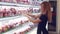 Beautiful caucasian young woman in supermarket choosing some healthy food