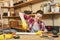 Beautiful caucasian young woman working in carpentry workshop at table place