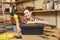 Beautiful caucasian young woman working in carpentry workshop at table place