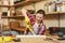 Beautiful caucasian young woman working in carpentry workshop at table place